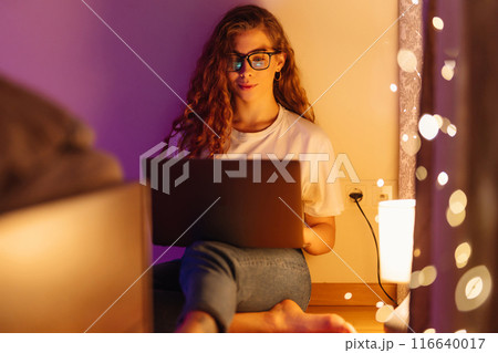 Woman working online on laptop computer at home. Business, blogging, freelance, education concept. 116640017