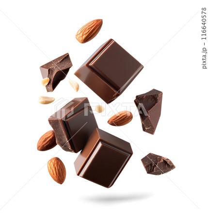 Chocolate falling with nuts on white backgrounds Chocolate falling with nuts on white backgrounds 116640578