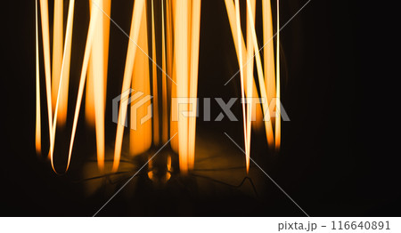 Tungsten filament of vintage lamp glowing in dark, macro photo Tungsten filament of vintage lamp glowing in dark, macro photo 116640891