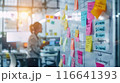 Whiteboard Full of Colorful Sticky Notes in Dynamic Work Environment 116641393