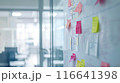 Whiteboard Full of Colorful Sticky Notes in Dynamic Work Environment 116641398