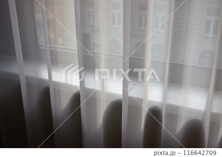 Window curtain in a plain hotel room 116642709
