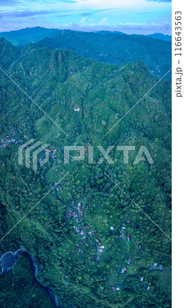Aerial view The waterfall stream flows into the mountain gorge in a long path. Aerial view The waterfall stream flows into the mountain gorge in a long path. 116643563