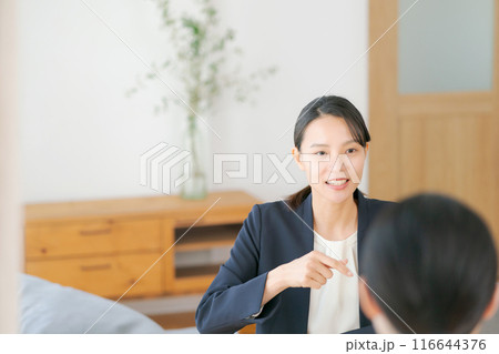 家で親子と話すスーツの女性 家で親子と話すスーツの女性 116644376