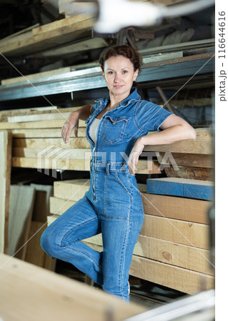 Portrait of positive female lumber warehouse worker Portrait of positive female lumber warehouse worker 116644616