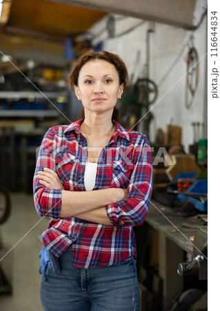 Adult woman posing in oak workshop 116644834