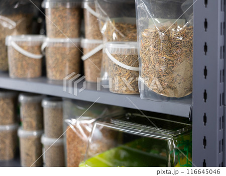 Pet shop display shelf with packages of pellets for feeding turtles Pet shop display shelf with packages of pellets for feeding turtles 116645046