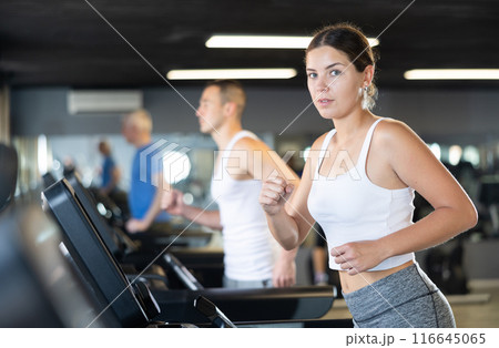 Girl walk on treadmill in gym. Healthy lifestyle, extensive training 116645065