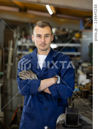 Young man posing in oak workshop 116645288
