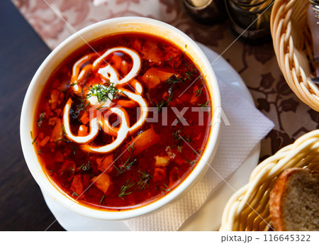 Traditional Russian meat soup solyanka with assorted meat and sausages and vegetables 116645322