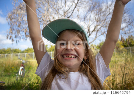 The little girl smiles. Permanent teeth appeared. The little girl smiles. Permanent teeth appeared. 116645794