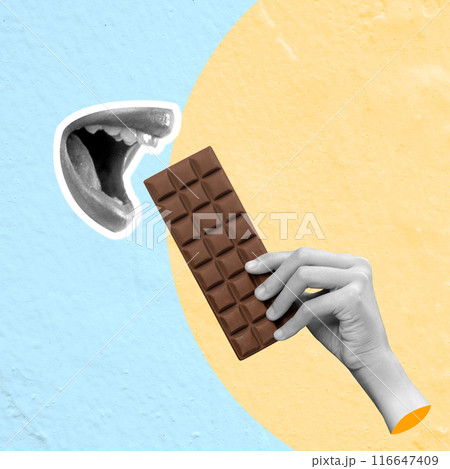 A human hand eats a chocolate bar 116647409