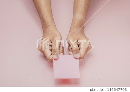 A human hand holding a note A human hand holding a note 116647708