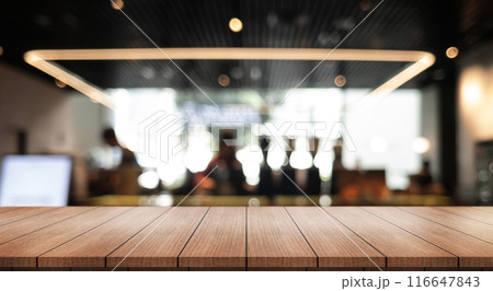 Empty wooden table top with lights bokeh on blur restaurant background. Empty wooden table top with lights bokeh on blur restaurant background. 116647843