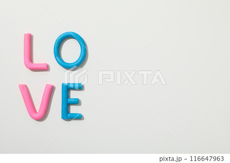 The word "love" is made of colored plasticine on a white background. 116647963