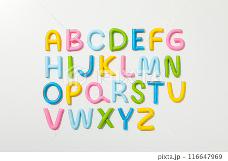 Alphabet made of colored plasticine on a light background. 116647969