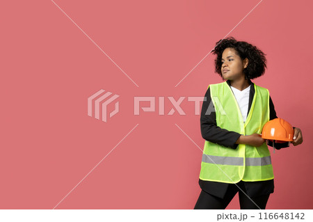 A young girl in the form of a construction worker with a hard hat 116648142