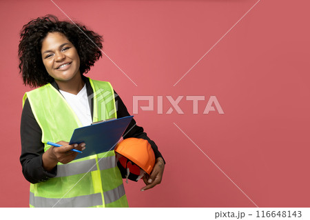 A young girl in the form of a construction worker with a hard hat 116648143