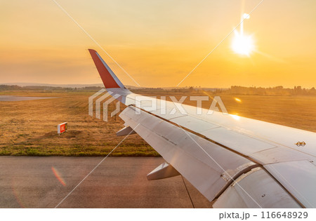 View on sunset and airplane wing from the inside View on sunset and airplane wing from the inside 116648929