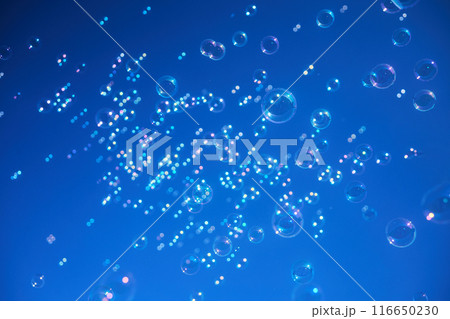 Colorful bubbles floating against a vibrant blue sky Colorful bubbles floating against a vibrant blue sky 116650230