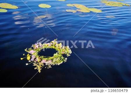 Midsummer background. Flower Wreath on Water 116650479