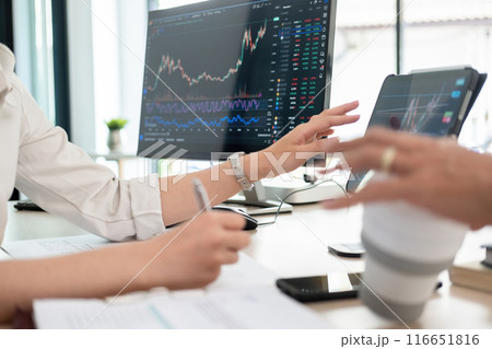 Young woman examines stock graphs at tablet Young woman examines stock graphs at tablet 116651816