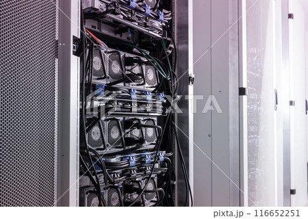 A row of racks with data storage hardware inside server room 116652251