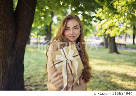 beautiful teenage girl in peach fuzz suit with vest, old money style with craft gift certificate 116654944