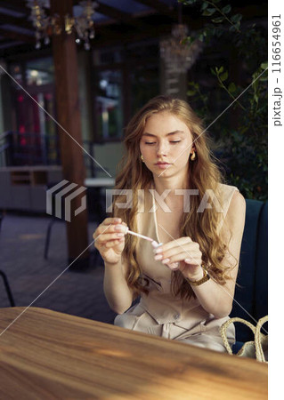 a beautiful teenage girl in a peach fuzz suit with a vest, in the old money style in a fancy restaurant a beautiful teenage girl in a peach fuzz suit with a vest, in the old money style in a fancy restaurant 116654961