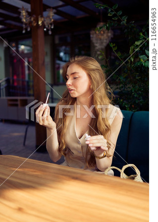 a beautiful teenage girl in a peach fuzz suit with a vest, in the old money style in a fancy restaurant a beautiful teenage girl in a peach fuzz suit with a vest, in the old money style in a fancy restaurant 116654963