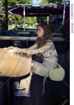 a beautiful teenage girl in a peach fuzz suit with a vest, in the old money style in a fancy restaurant a beautiful teenage girl in a peach fuzz suit with a vest, in the old money style in a fancy restaurant 116655056