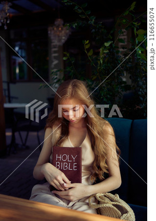 beautiful teenage girl in a peach fluffy suit with a waistcoat in the old money style reads the Holy Bible and prays beautiful teenage girl in a peach fluffy suit with a waistcoat in the old money style reads the Holy Bible and prays 116655074