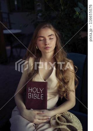 beautiful teenage girl in a peach fluffy suit with a waistcoat in the old money style reads the Holy Bible and prays beautiful teenage girl in a peach fluffy suit with a waistcoat in the old money style reads the Holy Bible and prays 116655076