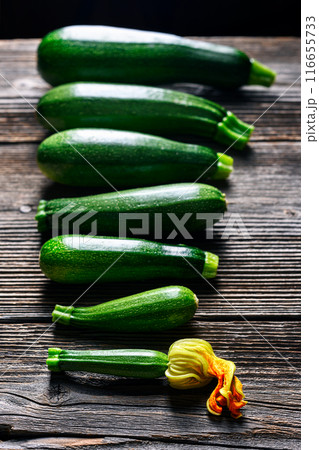 Zucchini laid out on a rustic wooden table in a row Zucchini laid out on a rustic wooden table in a row 116655733