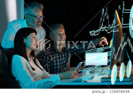 Team Analyzing Data on Digital Display in a Modern Office 116656056