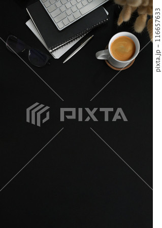 Stylish workspace with cup of coffee, notebook and computer keyboard on black table. Copy space for text Stylish workspace with cup of coffee, notebook and computer keyboard on black table. Copy space for text 116657633