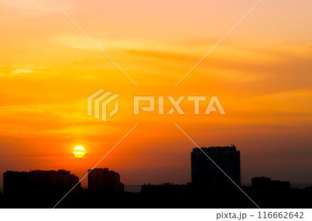 Sun Above the Rooftops in the Dawn Sky 116662642
