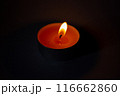 Candle on dark luxury night background. Black table, side view. Candles Burning at Night. Orange taper burning in focus, foreground. illustration design. 116662860