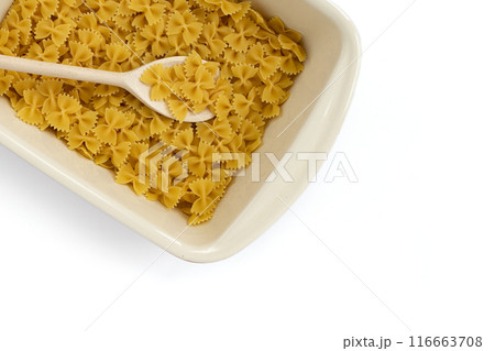 uncooked farfalle pasta in dish on white background 116663708