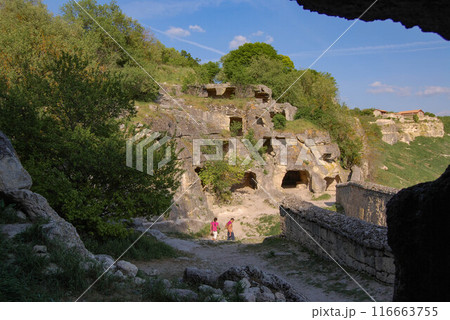 An ancient cave city in Crimea. In the rock you can see hollowed-out rooms that served as homes for ancient people. Ancient settlements. 116663755