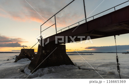 Old broken pier silhouette, winter landscape Old broken pier silhouette, winter landscape 116665369