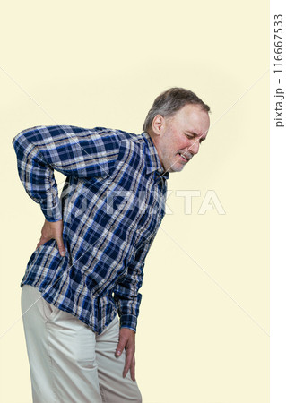 Mature senior caucasian man is having a back pain. Vertical shot white background. 116667533