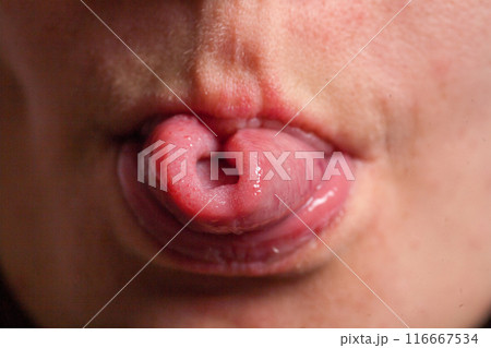 Female tongue. Close-up Of A Woman's Face Showing Her Clean Tongue 116667534