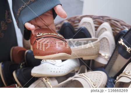 women choosing shoes at local store women choosing shoes at local store 116668269