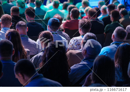 Audience attending a conference with focus on speaker Audience attending a conference with focus on speaker 116671617