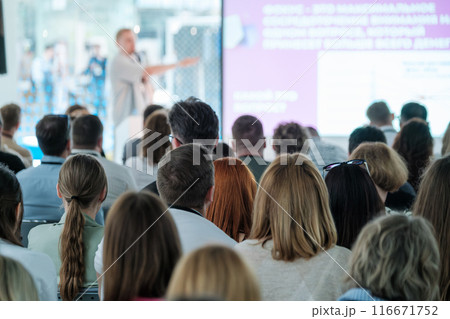 Audience listening to speaker during a business conference Audience listening to speaker during a business conference 116671752