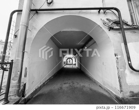 Monochrome view of urban tunnel with arches and pipes 116671909