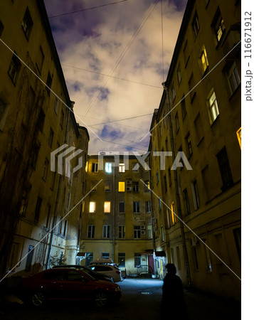 Mysterious urban night scene with illuminated building windows 116671912