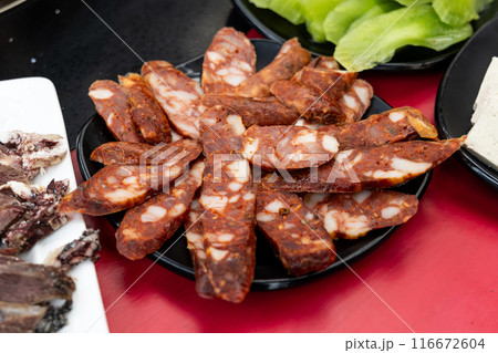 Serving of cured or preserved meat with mala as one of the ingredients in Tibetan hotpot or steamboat Serving of cured or preserved meat with mala as one of the ingredients in Tibetan hotpot or steamboat 116672604
