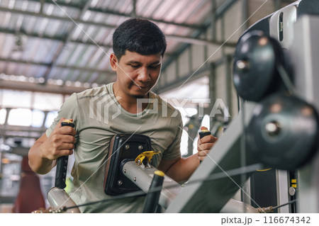 Asian man sportswear well trained body exercise lat pulldown in fitness gym. Asian man sportswear well trained body exercise lat pulldown in fitness gym. 116674342